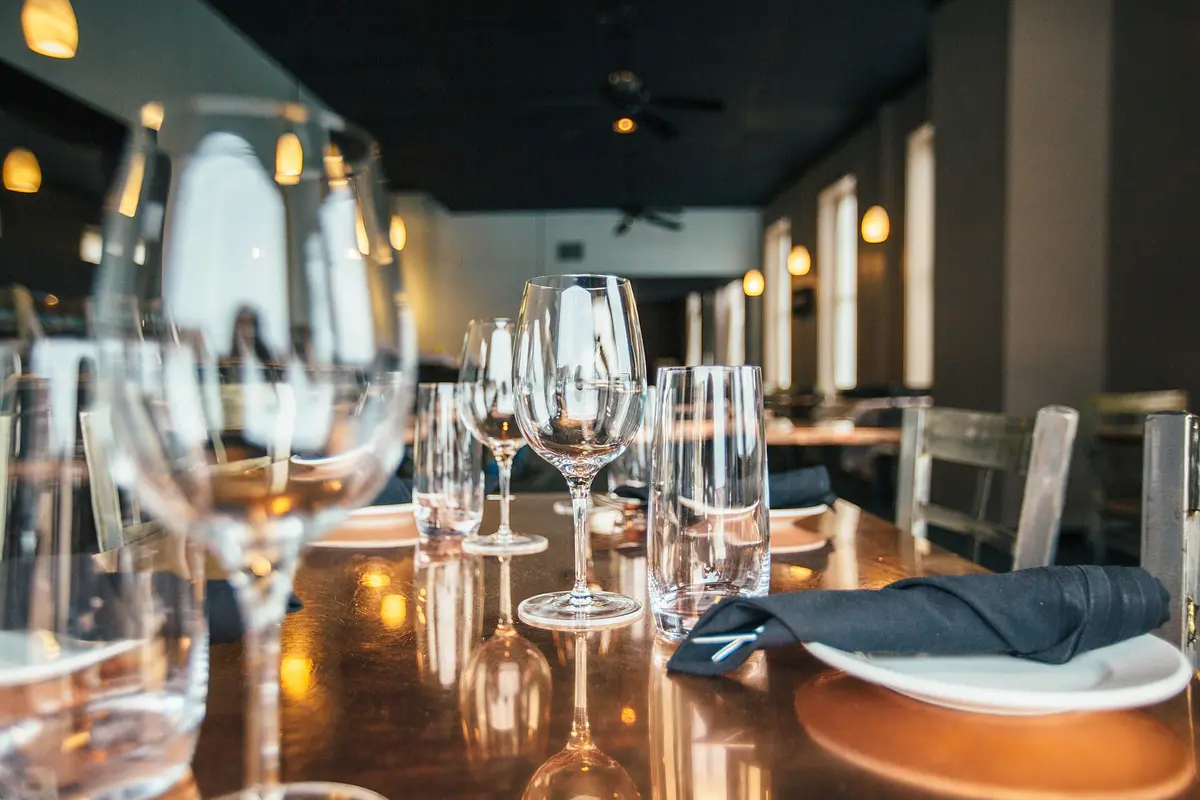 Wine glasses laid on a candle lit table