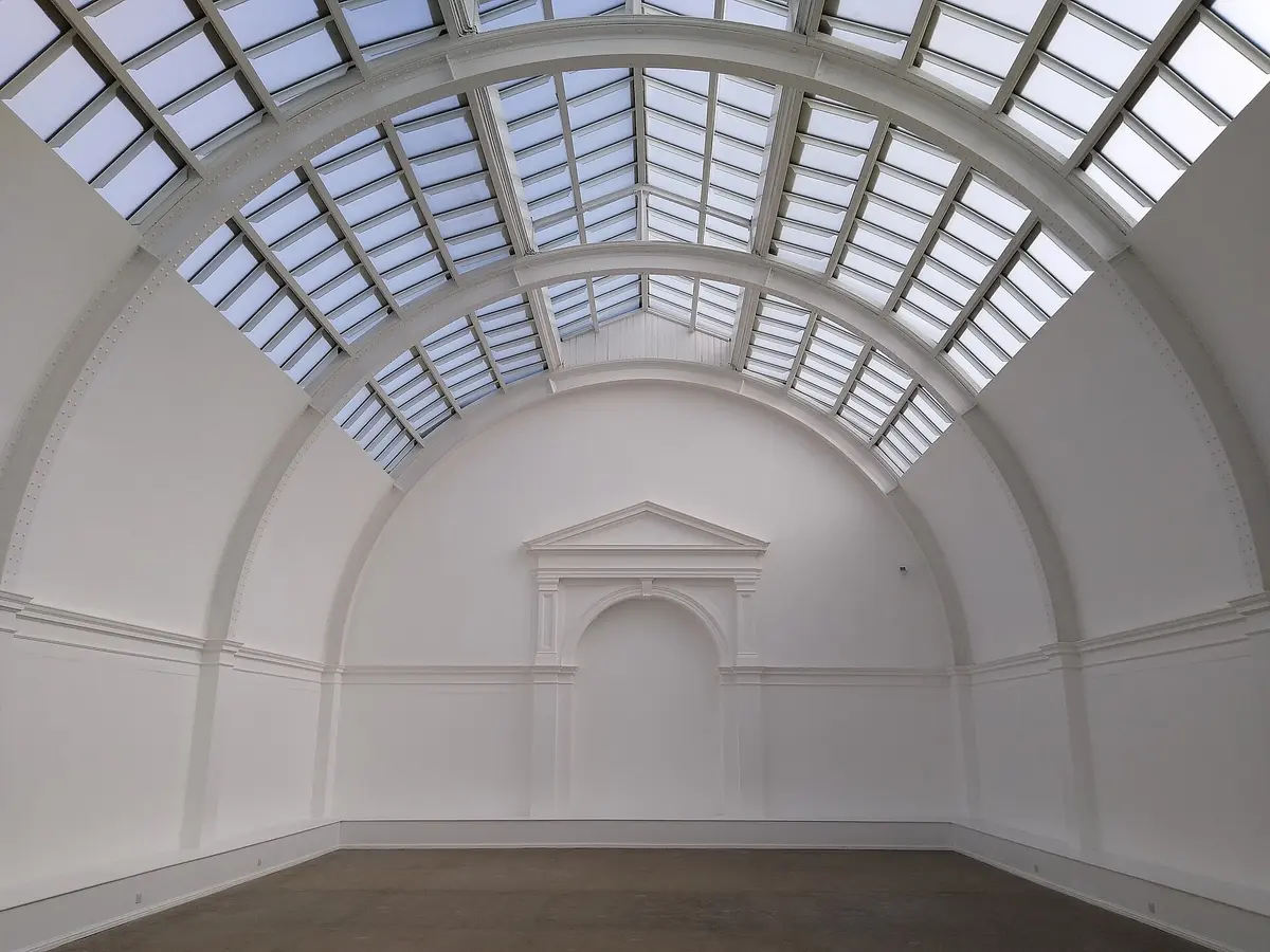 An empty gallery under a glass roof