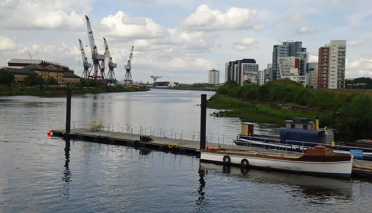 The River Clyde with dockyard cranes and the Glasgow skyline