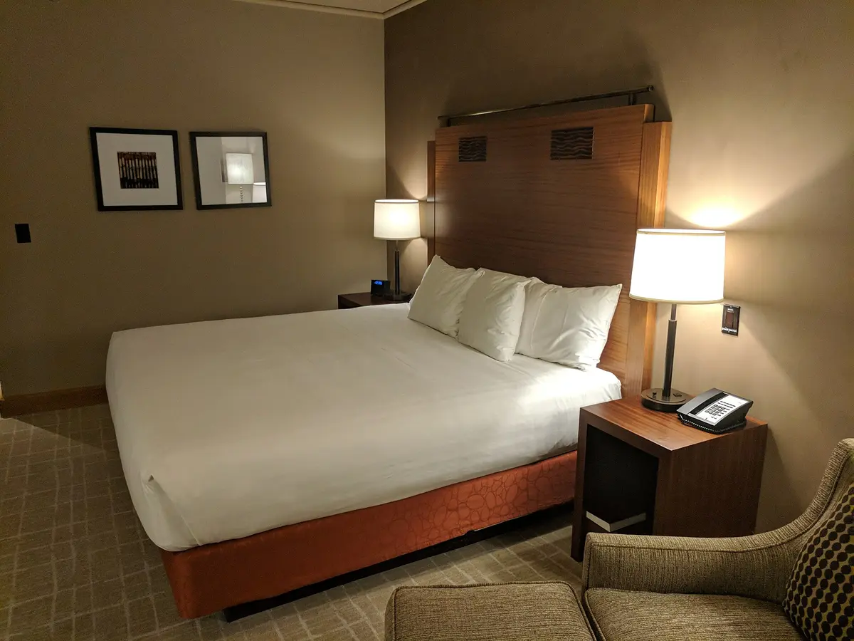 A quiet hotel room with bedside lamps on