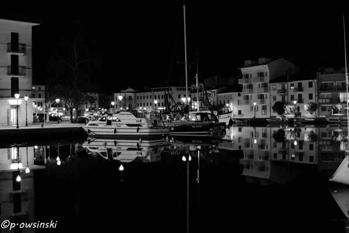 Boats moored in a harbour at night