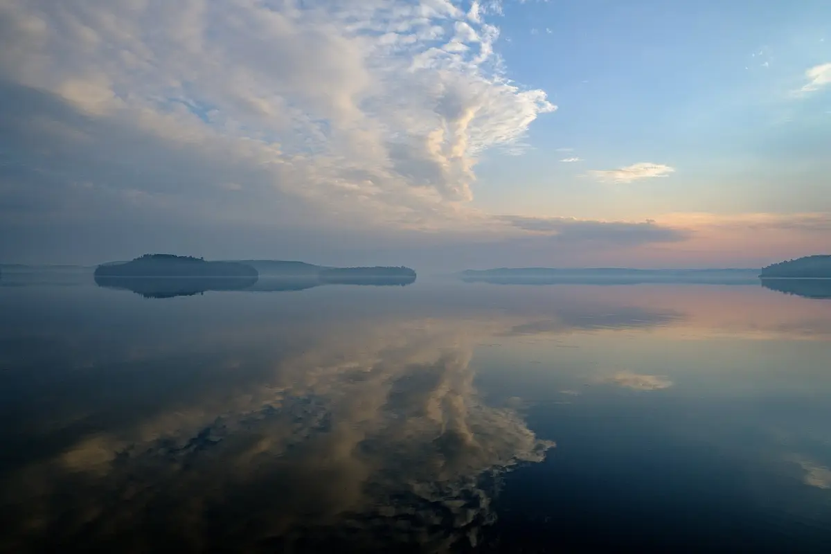 Still water reflecting an evening sky