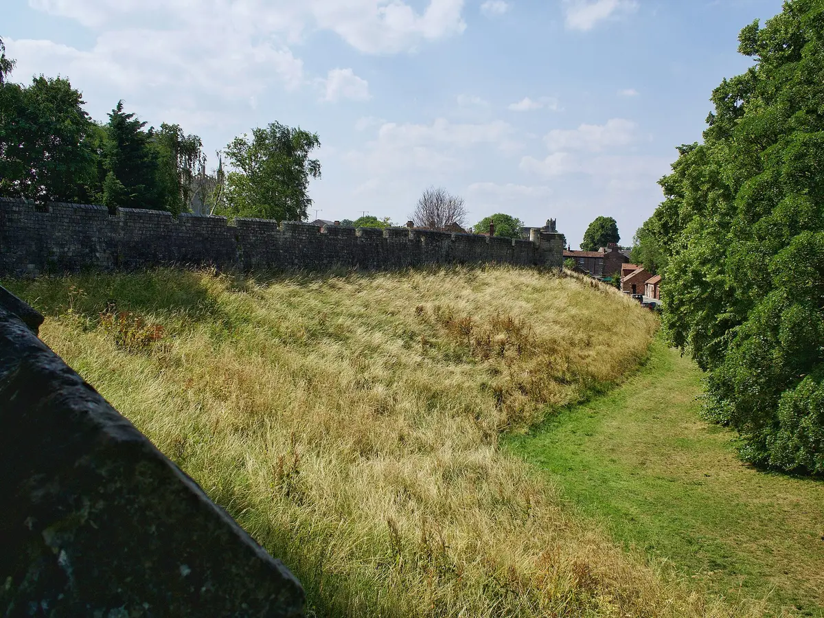 A stretch of York's city wall beside a grassy bank